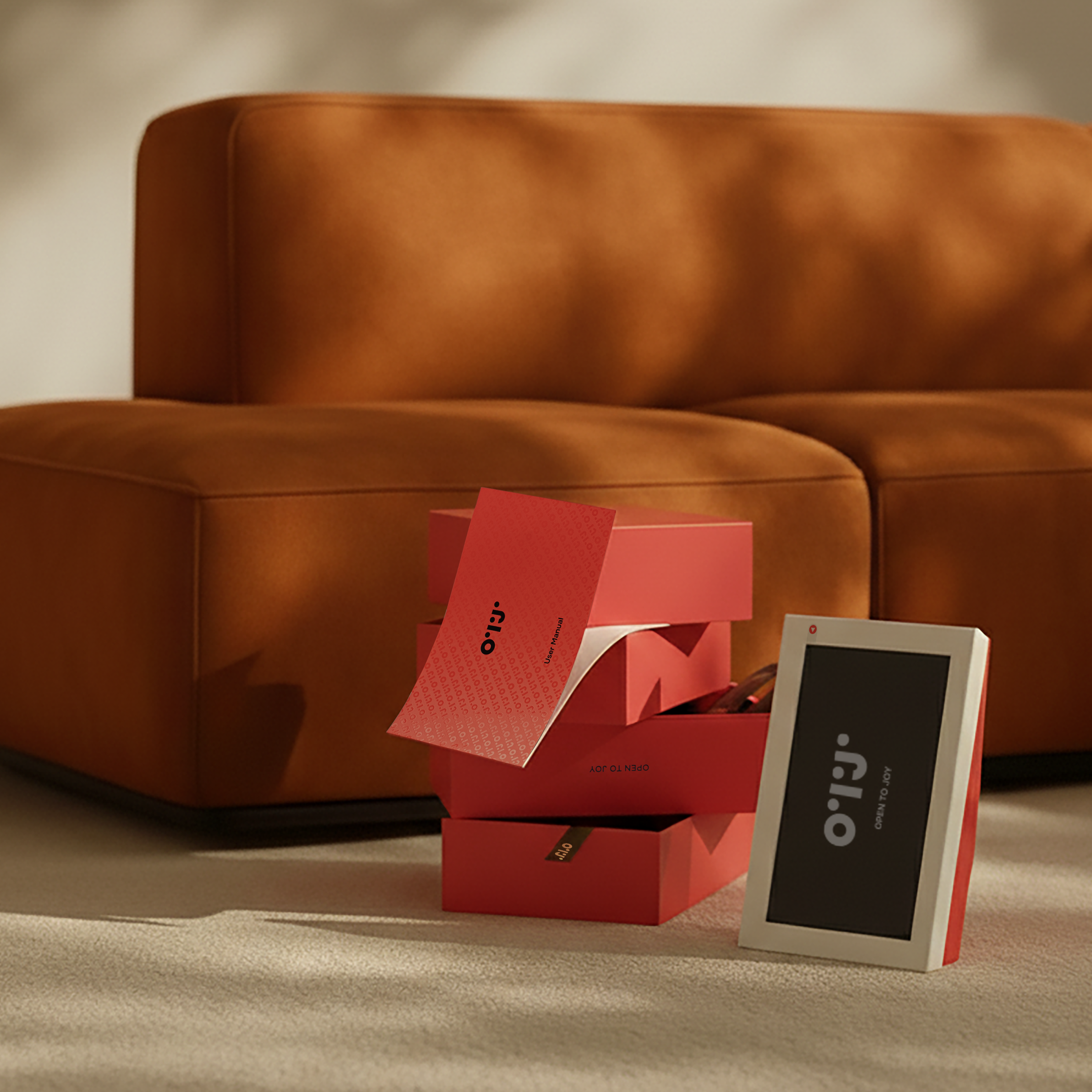 Red boxes with a digital device on a beige surface in front of a brown sofa.