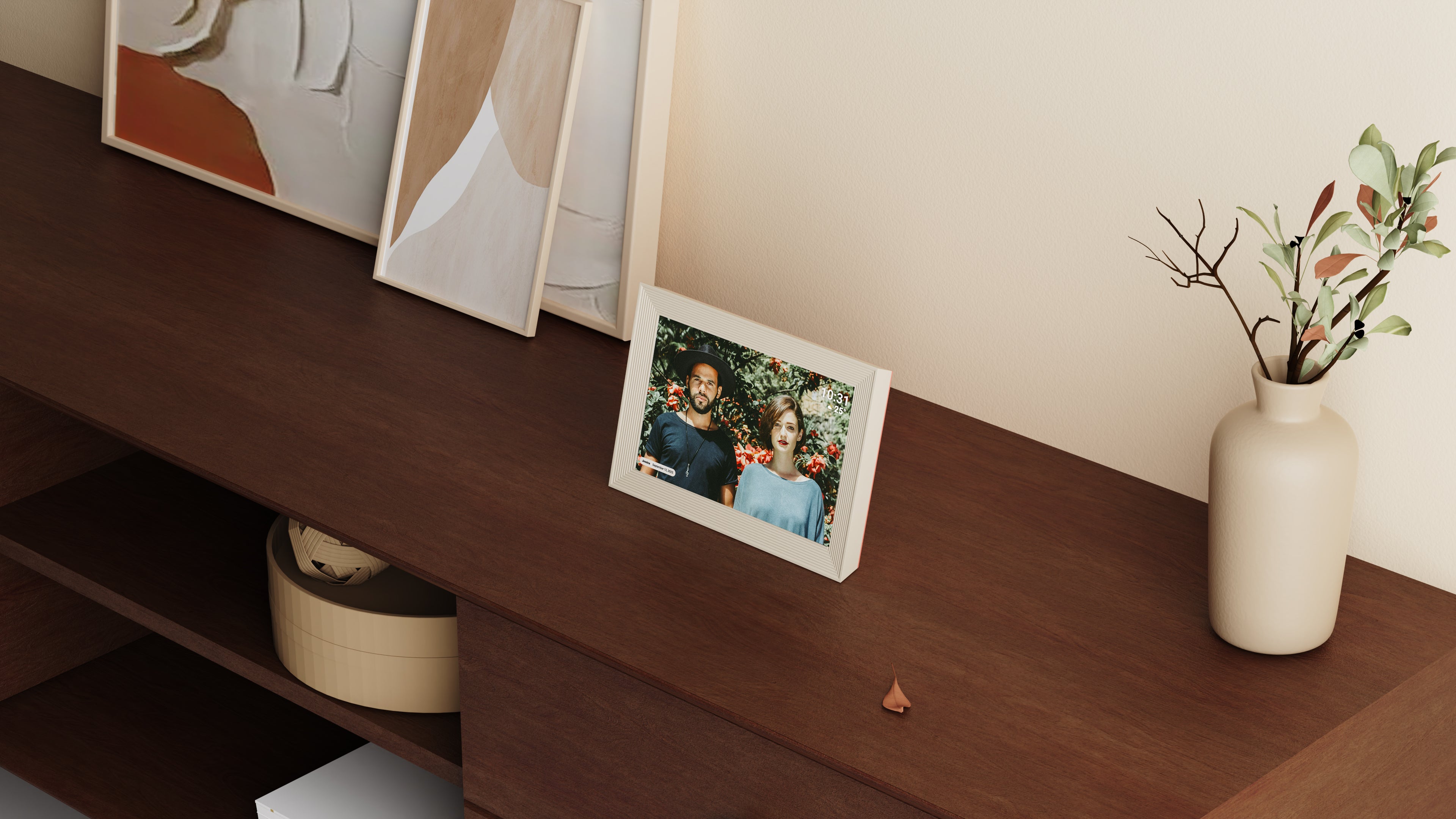 Digital photo frame on a wooden shelf with decorative items